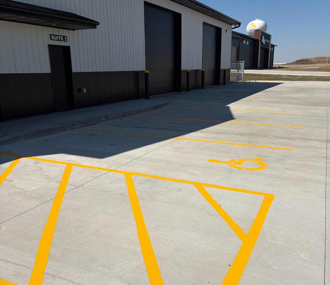 Freshly painted parking lot stripes on dark asphalt