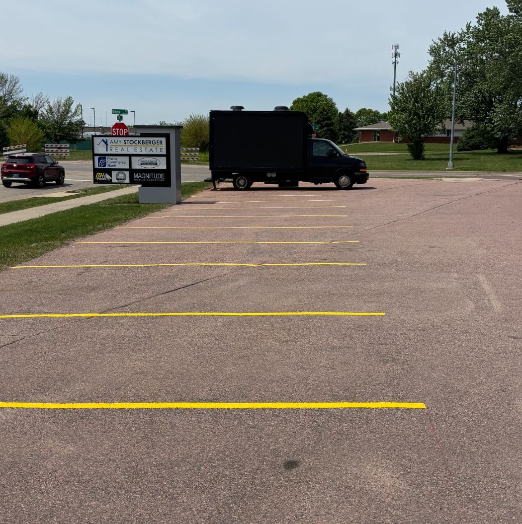 Large commercial asphalt lot with crisp new yellow striping
