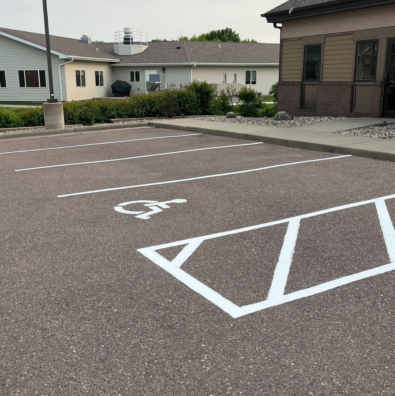 ADA stall and crosshatch access aisle freshly re-marked in white